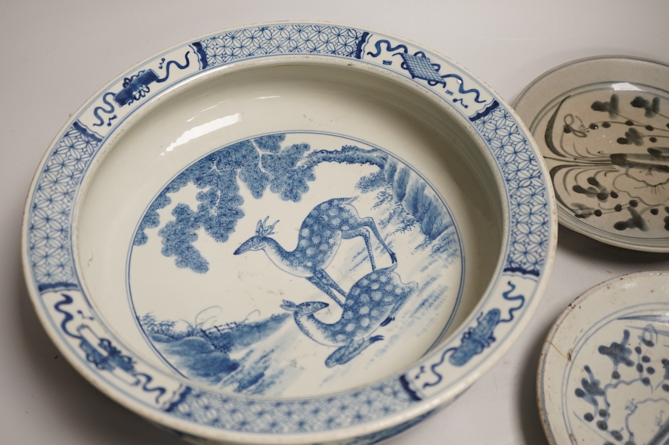 A Chinese blue and white bowl, tea bowl and saucer, and two other dishes, largest 29cm diameter